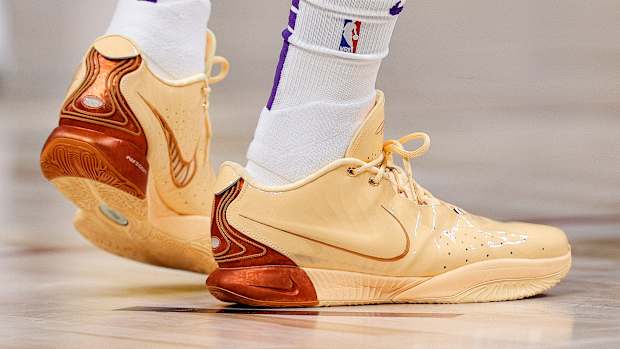 Side view of Los Angeles Lakers forward LeBron James' orange Nike sneakers.